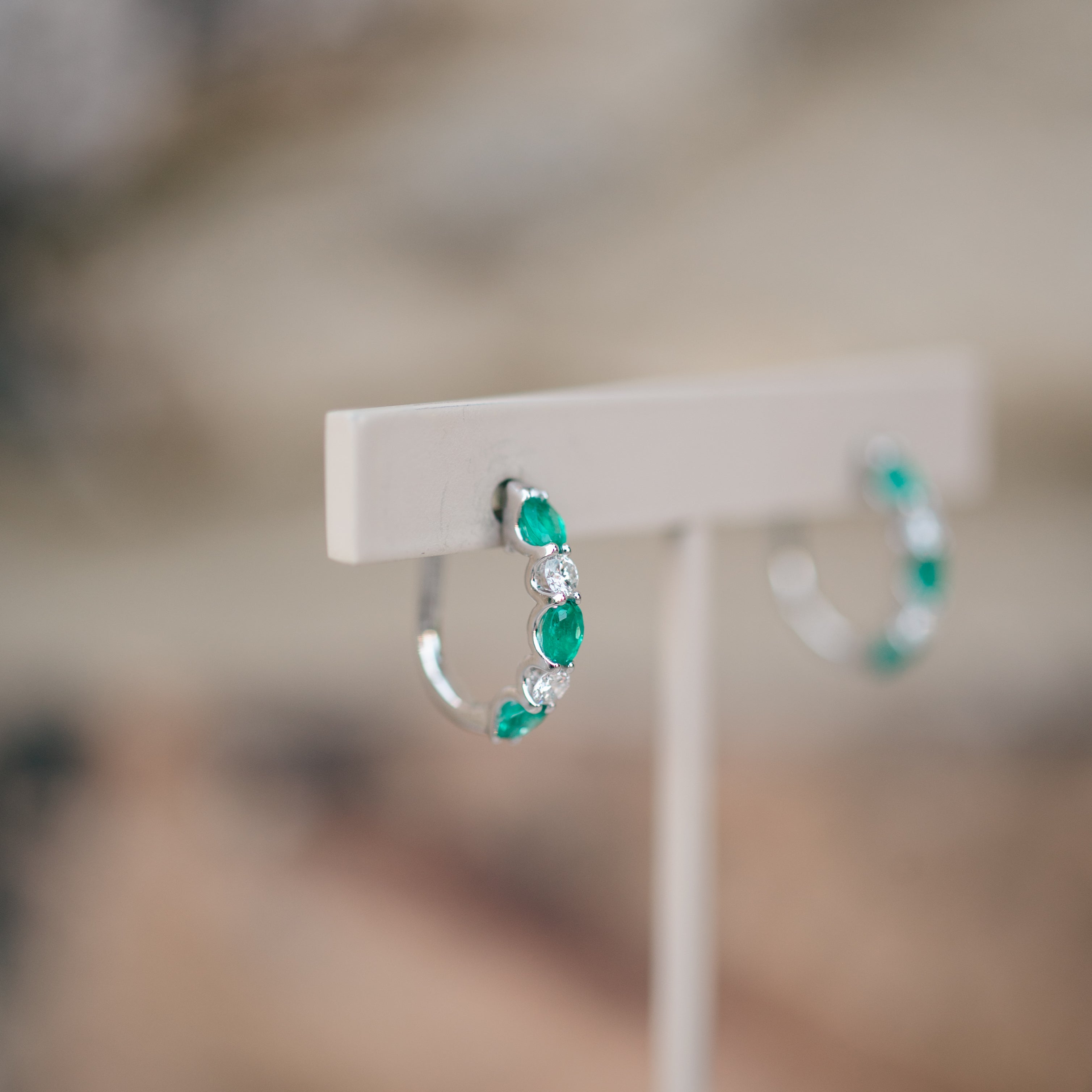 oval emerald and diamond hoops