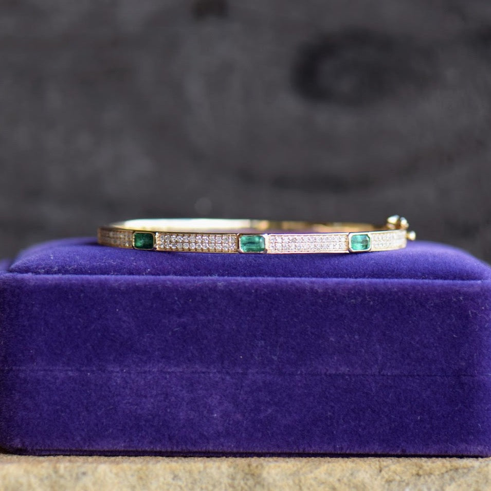 Emerald and diamond yellow gold bangle