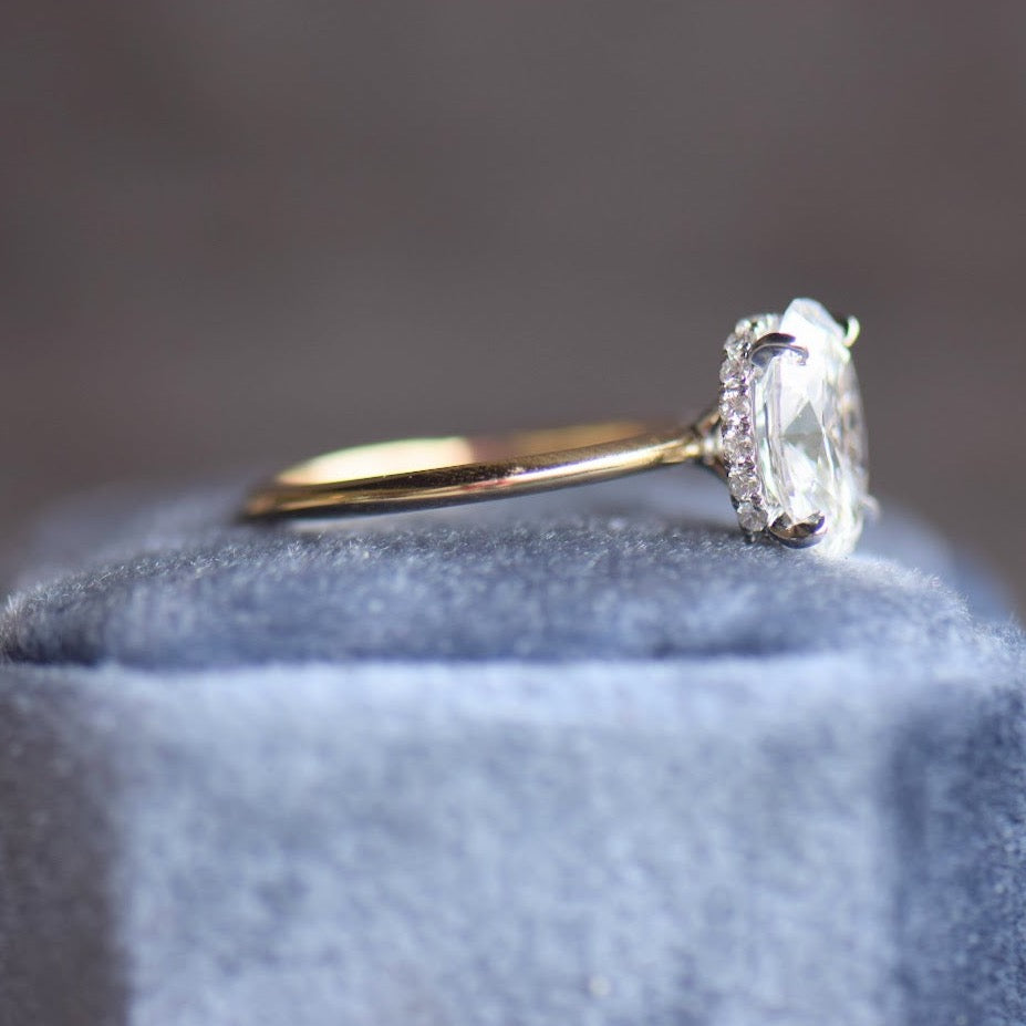 Oval diamond solitaire engagement ring with hidden halo