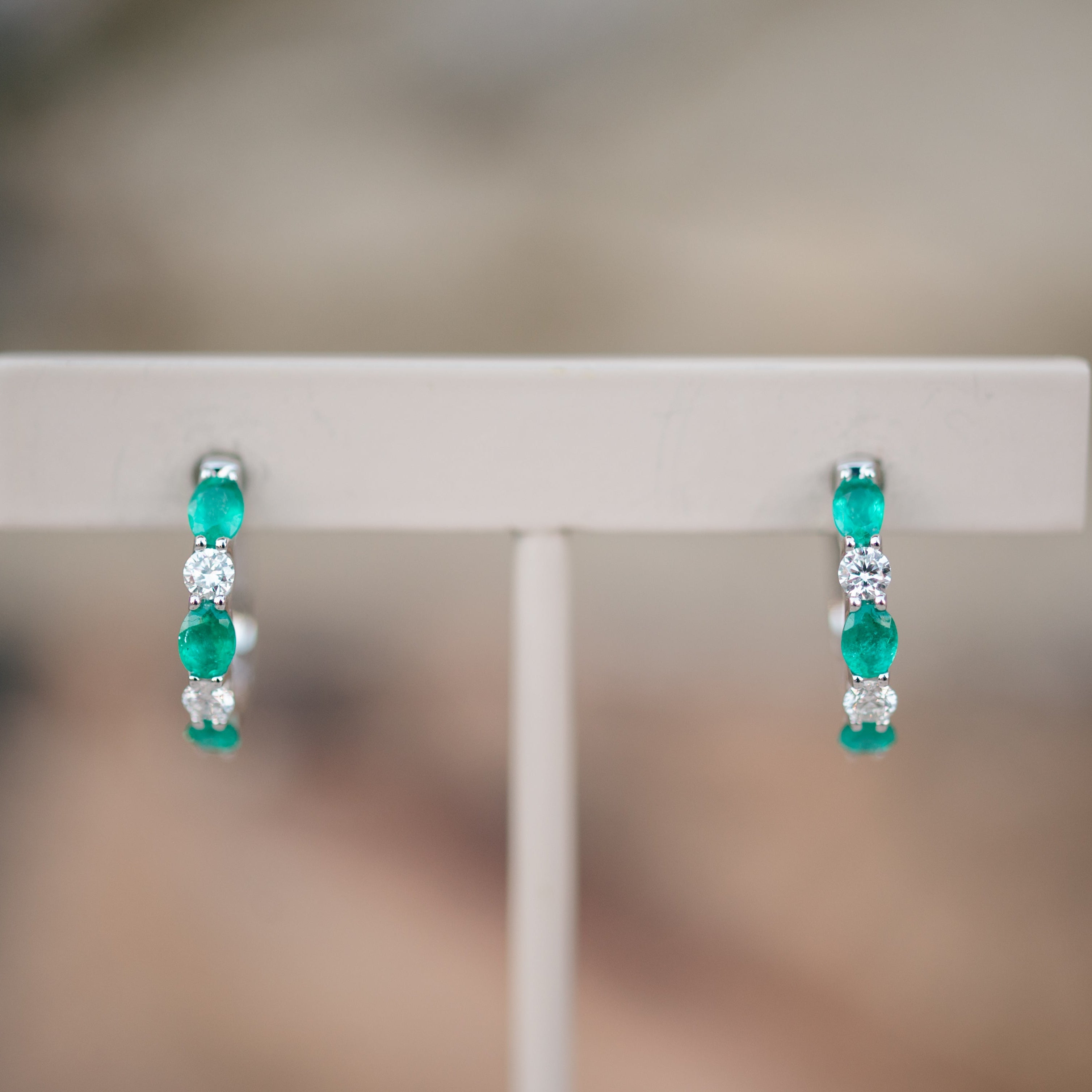 oval emerald and diamond hoops