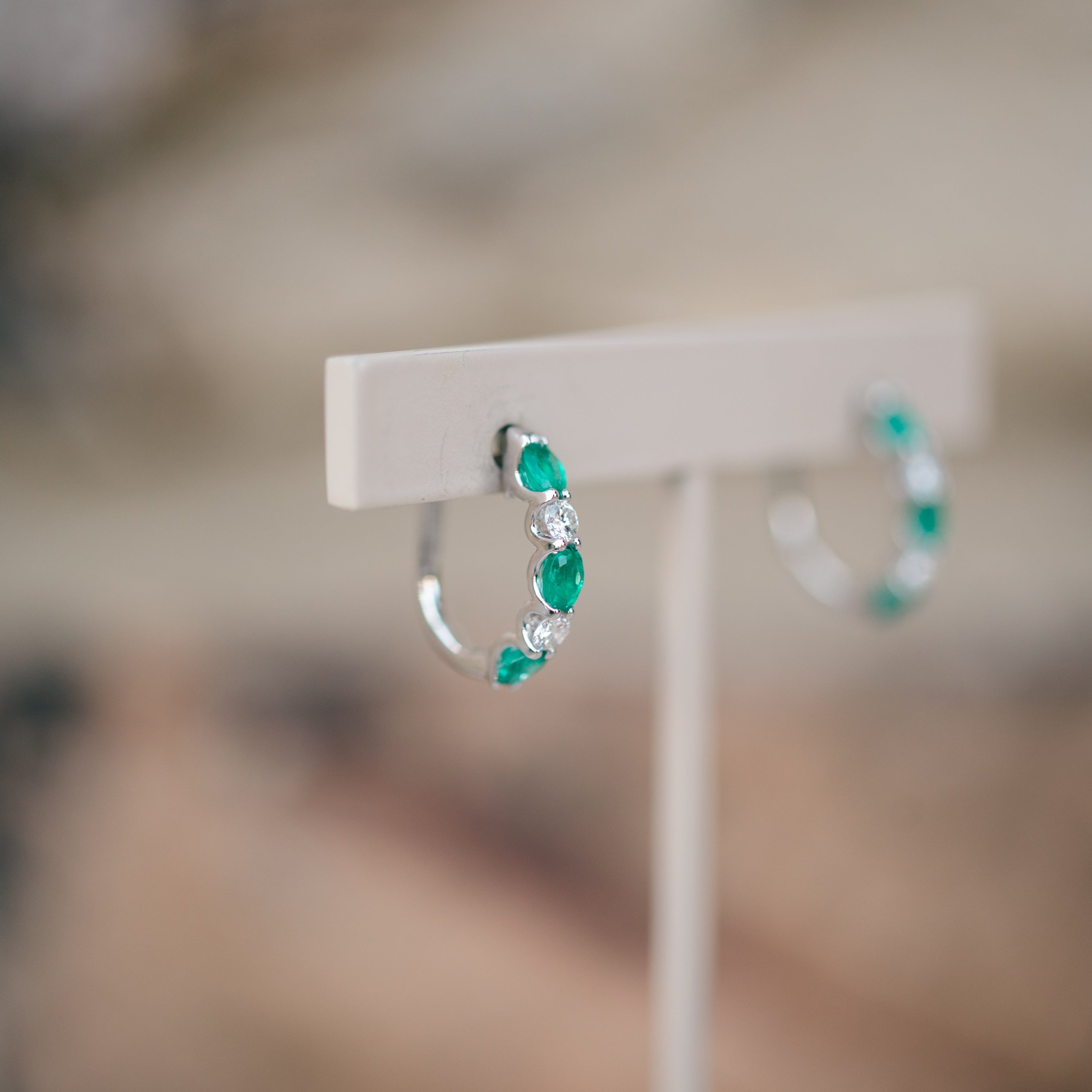 oval emerald and diamond hoops