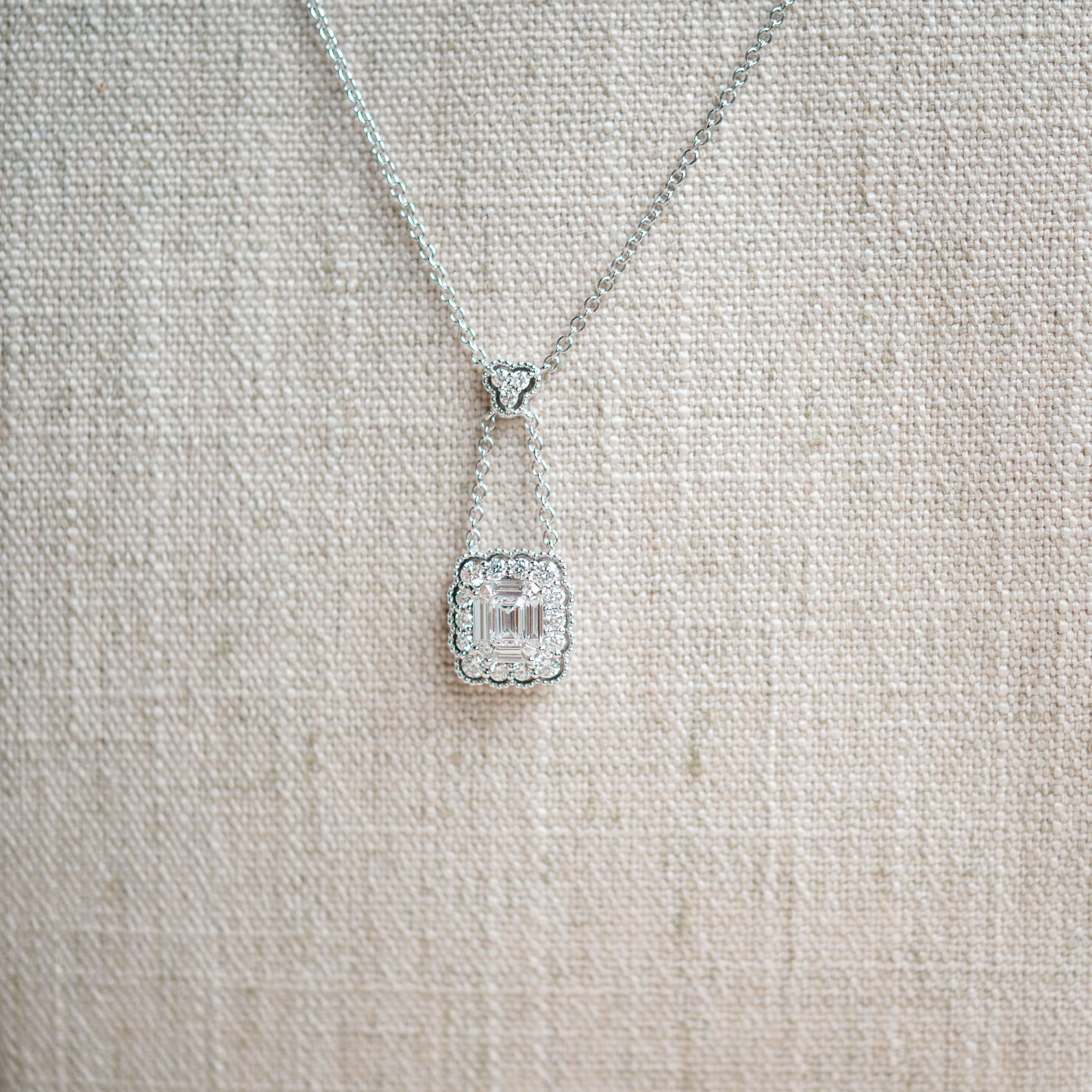 emerald cut diamond and scalloped diamond halo necklace