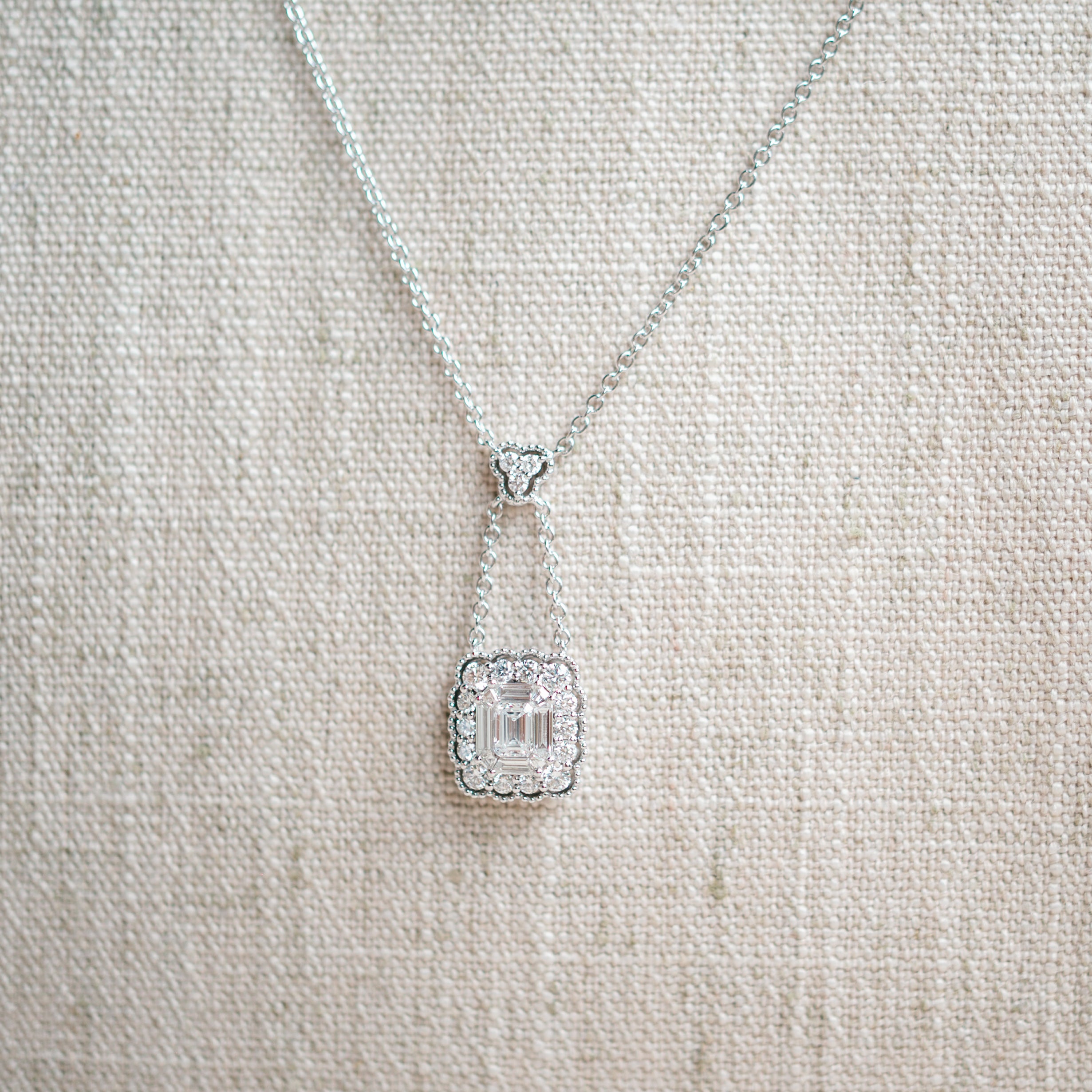 emerald cut diamond and scalloped diamond halo necklace