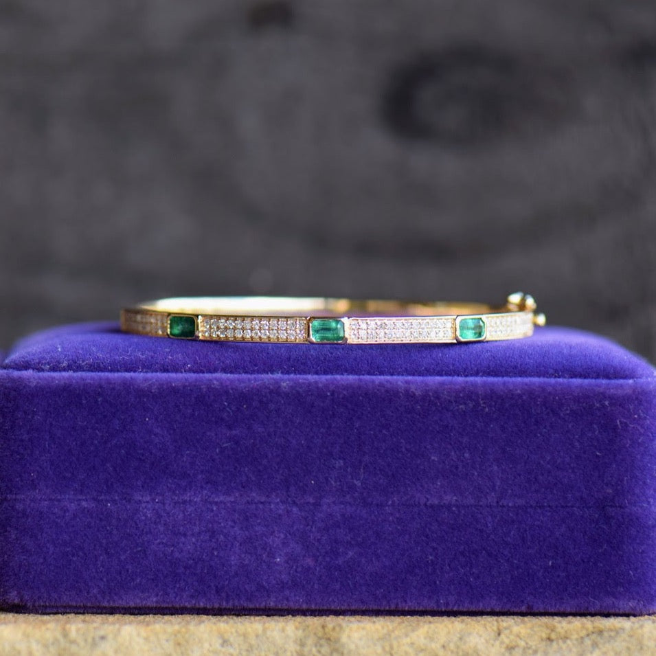 Emerald and diamond yellow gold bangle