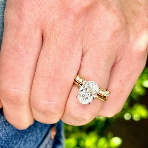 Oval diamond solitaire engagement ring with hidden halo