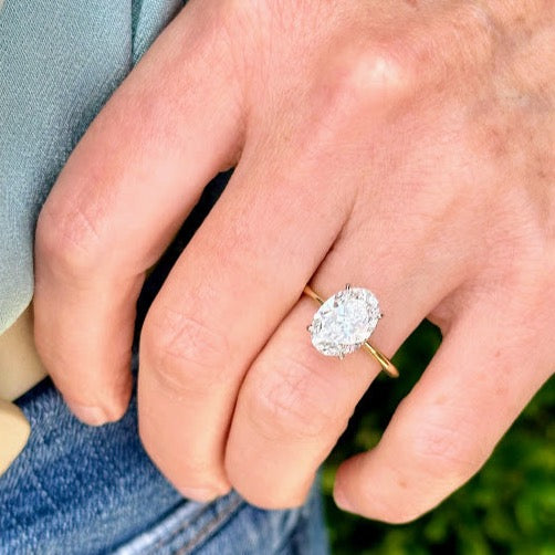 Oval diamond solitaire engagement ring with hidden halo